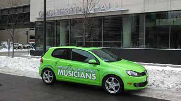 Minnesota flutist Adam Kuenzel’s MoMOmobile is appropriately parked outside of Orchestra Hall during the lockout. MoMO is the acronym of the Musicians of the Minnesota Orchestra. Adam used the color scheme used in MoMO lawn signs, T-shirts, and buttons. Will an Osmomobile follow?Photo credit: Adam Kuenzel